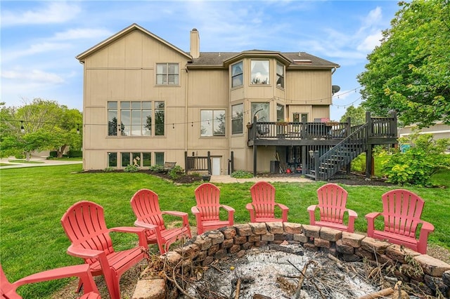 15998 Overbrook Ln, Overland Park, KS 66224 - rear view of house featuring stairs, an outdoor fire pit, a deck, a chimney, and a lawn