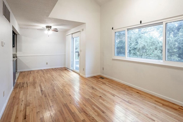 255 N Michigan St Unit 1-2, Lawrence, KS 66044 - empty room with light wood-style flooring, ceiling fan, and baseboards
