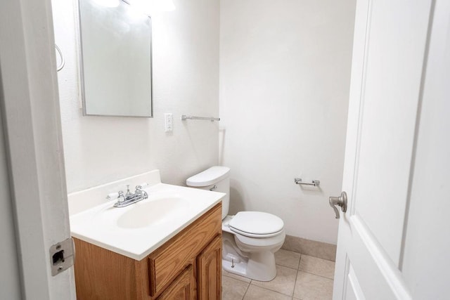 255 N Michigan St Unit 1-2, Lawrence, KS 66044 - bathroom with vanity, toilet, and tile patterned flooring