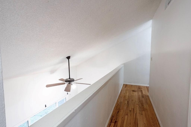 255 N Michigan St Unit 1-2, Lawrence, KS 66044 - corridor with wood finished floors, a textured ceiling, and baseboards