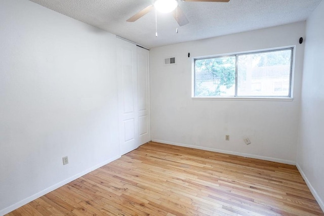 255 N Michigan St Unit 1-2, Lawrence, KS 66044 - empty room with light wood finished floors, ceiling fan, baseboards, and a textured ceiling