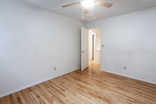 255 N Michigan St Unit 1-2, Lawrence, KS 66044 - empty room featuring light wood-style floors, ceiling fan, and baseboards