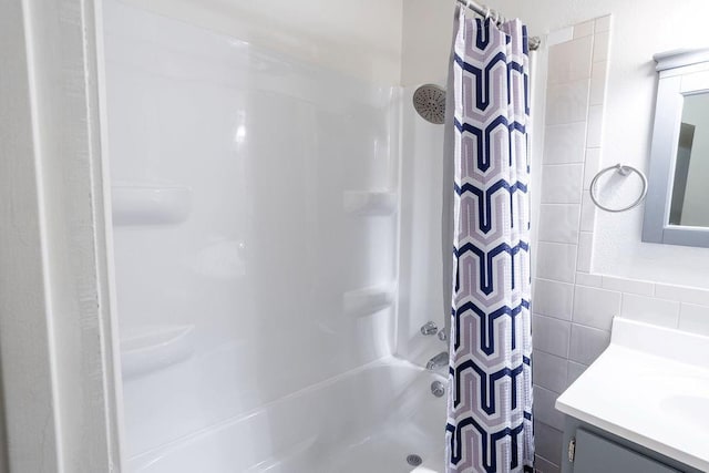 255 N Michigan St Unit 1-2, Lawrence, KS 66044 - bathroom with vanity, tile walls, and shower / bathtub combination with curtain