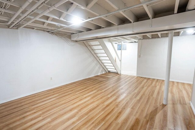255 N Michigan St Unit 1-2, Lawrence, KS 66044 - finished basement with wood finished floors, stairs, and baseboards