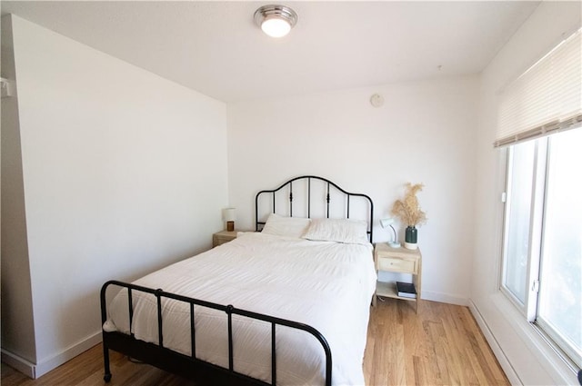 1739 W 26th St, Lawrence, KS 66047 - bedroom featuring light wood-style flooring and baseboards