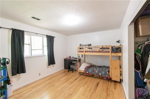 1739 W 26th St, Lawrence, KS 66047 - bedroom featuring wood finished floors and a textured ceiling