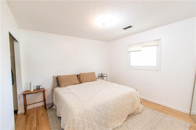 1739 W 26th St, Lawrence, KS 66047 - bedroom with wood finished floors and a textured ceiling