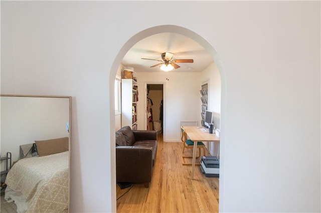 1739 W 26th St, Lawrence, KS 66047 - bedroom with arched walkways, light wood-style floors, and ceiling fan