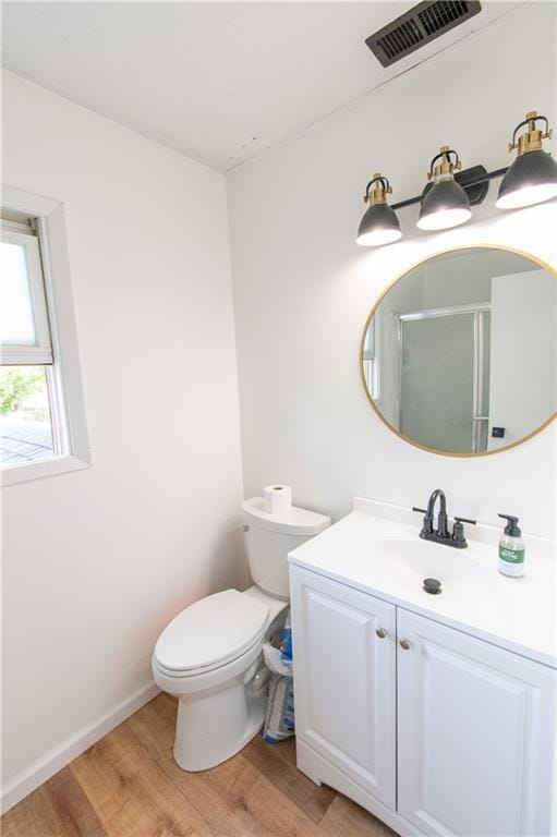 1739 W 26th St, Lawrence, KS 66047 - full bath featuring wood finished floors, vanity, and a shower with door