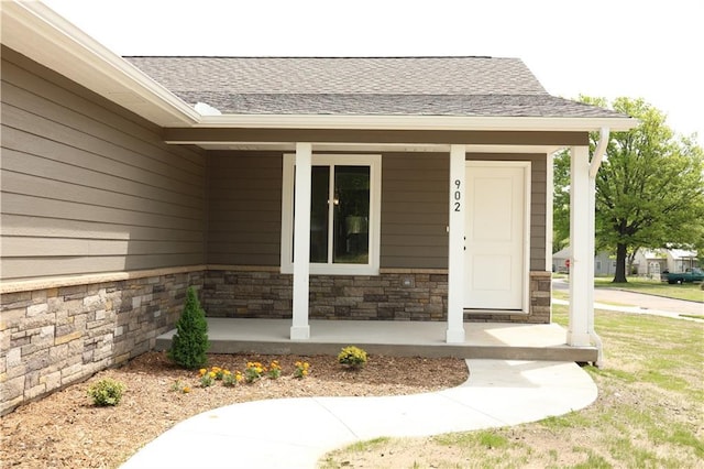 902 N 9th St, Neodesha, KS 66757 - property entrance with covered porch, roof with shingles, and stone siding