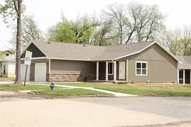 902 N 9th St, Neodesha, KS 66757 - single story home with an attached garage, a front lawn, concrete driveway, and stone siding