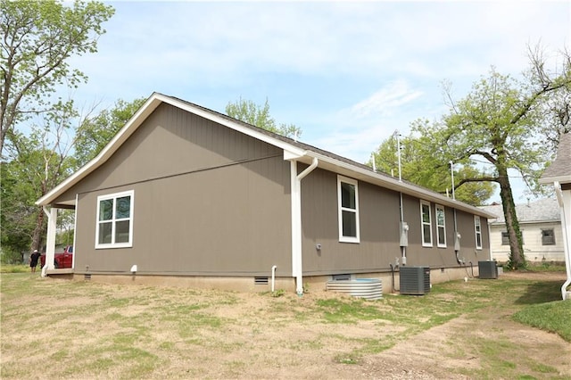 902 N 9th St, Neodesha, KS 66757 - view of side of property featuring a central AC unit and crawl space