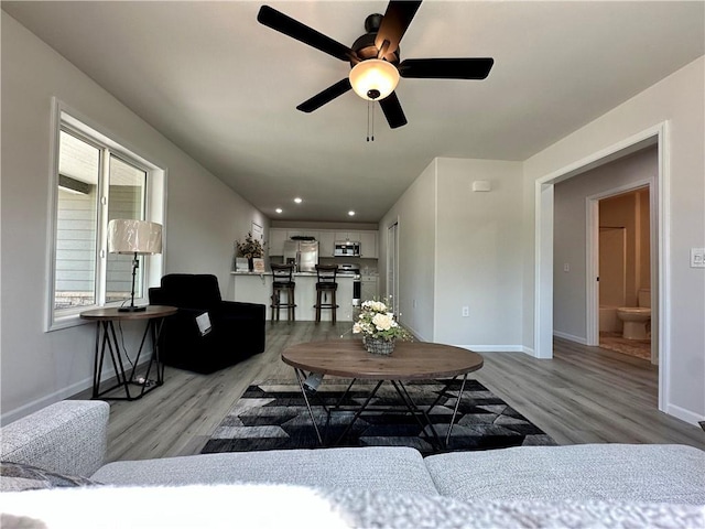 902 N 9th St, Neodesha, KS 66757 - living room featuring light wood-style floors, ceiling fan, and recessed lighting