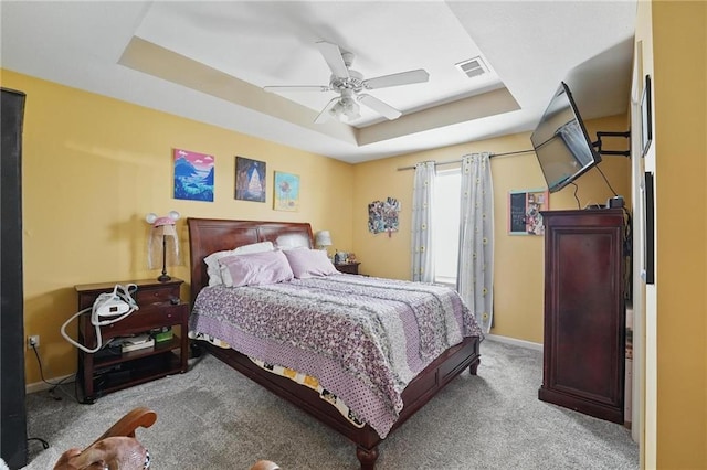 207 N Laurel St Unit 5D, Gardner, KS 66030 - bedroom with a tray ceiling, light carpet, and a ceiling fan
