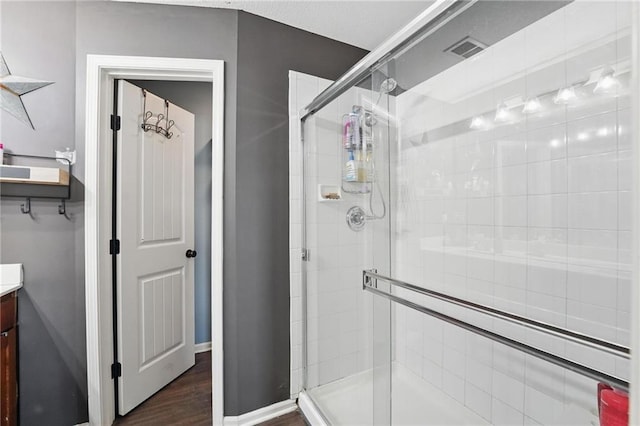 207 N Laurel St Unit 5D, Gardner, KS 66030 - full bath featuring a shower stall, vanity, and wood finished floors