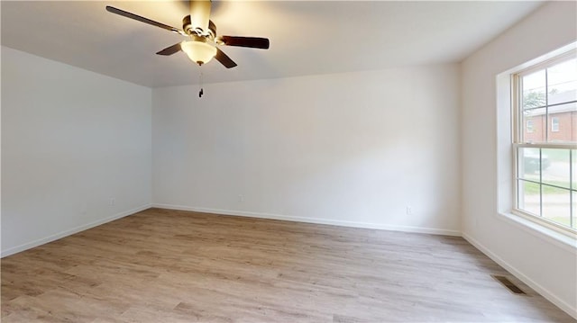 118 W Hickory St, Nevada, MO 64772 - unfurnished room with healthy amount of natural light, ceiling fan, and light wood finished floors