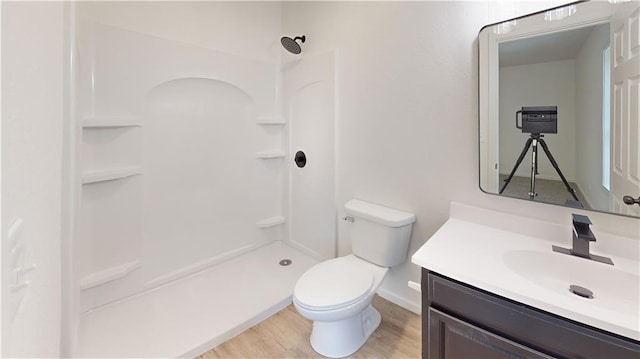 118 W Hickory St, Nevada, MO 64772 - full bathroom featuring vanity, a shower, and wood finished floors
