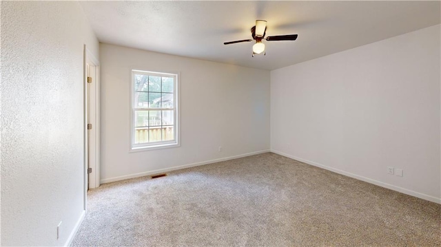 118 W Hickory St, Nevada, MO 64772 - unfurnished room with carpet floors and ceiling fan