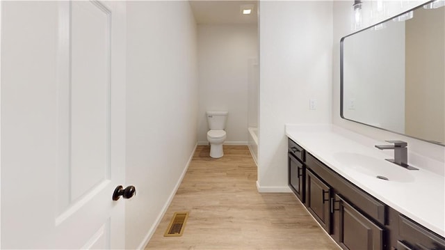 118 W Hickory St, Nevada, MO 64772 - full bathroom with vanity and wood finished floors