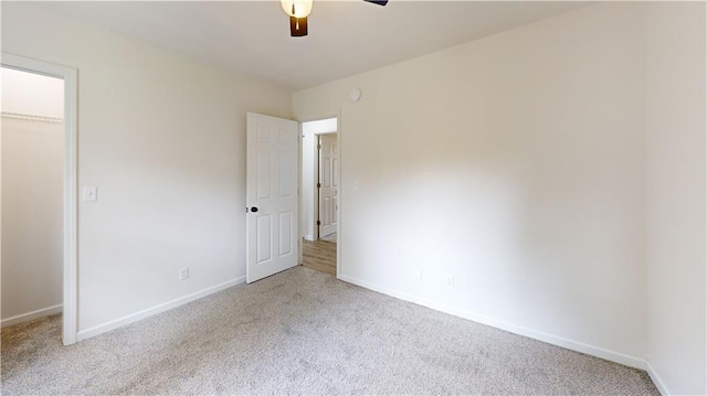 118 W Hickory St, Nevada, MO 64772 - unfurnished bedroom with carpet, a ceiling fan, and a closet