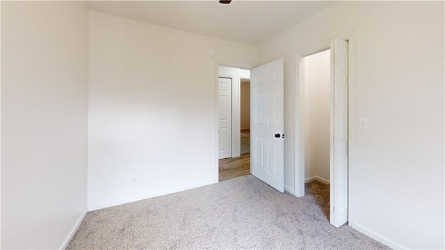 118 W Hickory St, Nevada, MO 64772 - unfurnished bedroom featuring light colored carpet and baseboards