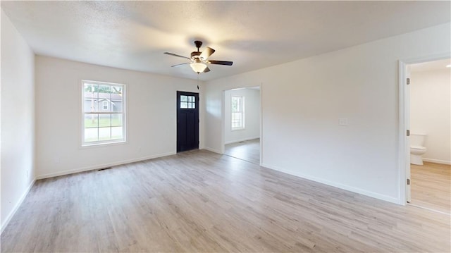 118 W Hickory St, Nevada, MO 64772 - unfurnished living room featuring healthy amount of natural light and light wood finished floors