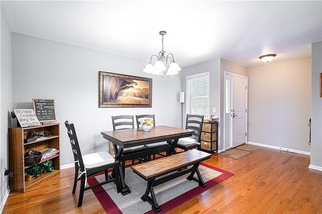3206 Sheffield Ln, Saint Joseph, MO 64506 - dining space with a chandelier, light wood finished floors, and baseboards