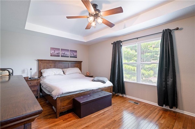 3206 Sheffield Ln, Saint Joseph, MO 64506 - bedroom featuring baseboards, a tray ceiling, light wood-style flooring, and ceiling fan