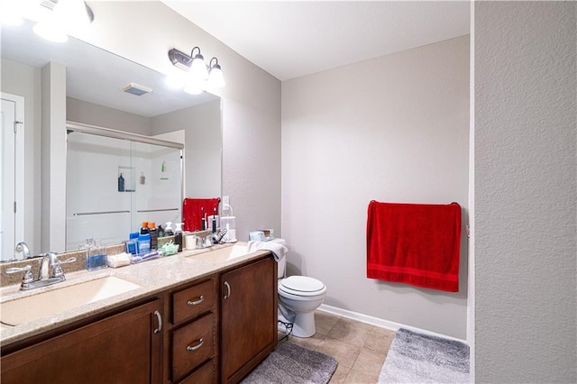 3206 Sheffield Ln, Saint Joseph, MO 64506 - full bathroom featuring a stall shower, double vanity, toilet, tile patterned flooring, and baseboards