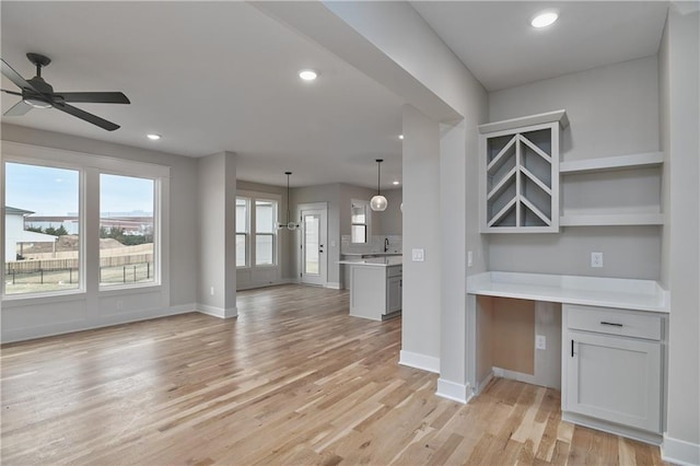 6018 Arapahoe St, Shawnee, KS 66226 - kitchen with open shelves, open floor plan, light countertops, baseboards, and recessed lighting