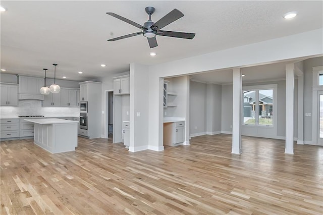 6018 Arapahoe St, Shawnee, KS 66226 - unfurnished living room with light wood-style flooring, ceiling fan, recessed lighting, and baseboards
