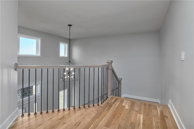 6018 Arapahoe St, Shawnee, KS 66226 - staircase with wood finished floors, baseboards, and a chandelier