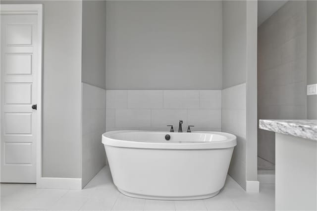 6018 Arapahoe St, Shawnee, KS 66226 - bathroom with a freestanding bath, tile patterned floors, and tile walls