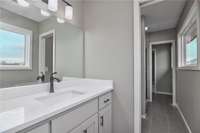 6018 Arapahoe St, Shawnee, KS 66226 - bathroom with tile patterned floors, vanity, and baseboards