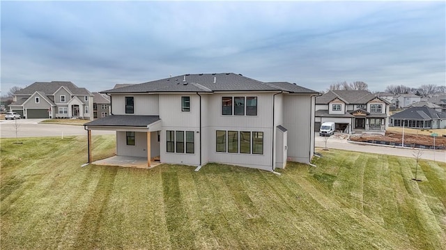 6018 Arapahoe St, Shawnee, KS 66226 - rear view of property featuring a residential view, a lawn, and a patio