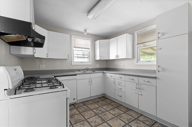 506 Hereford Ave, Independence, MO 64055 - kitchen with white appliances, wall chimney exhaust hood, healthy amount of natural light, and a sink