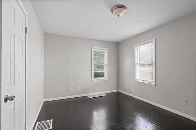 506 Hereford Ave, Independence, MO 64055 - unfurnished bedroom with baseboards and dark wood-style floors