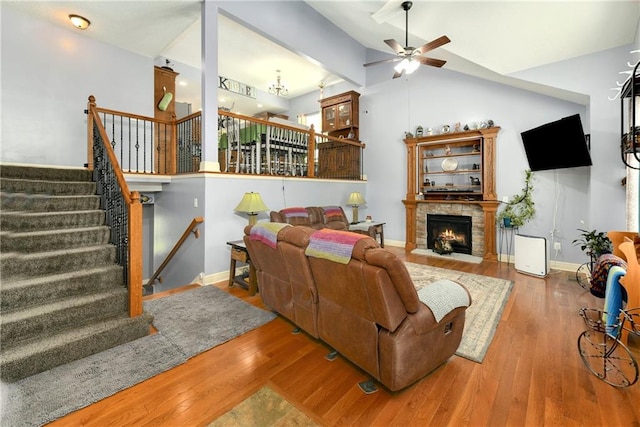 4316 Grand Ave, Leavenworth, KS 66048 - living room featuring ceiling fan, wood finished floors, lofted ceiling, stairway, and a lit fireplace