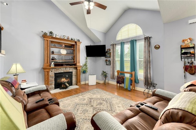 4316 Grand Ave, Leavenworth, KS 66048 - living room featuring a ceiling fan, vaulted ceiling, wood finished floors, a stone fireplace, and baseboards