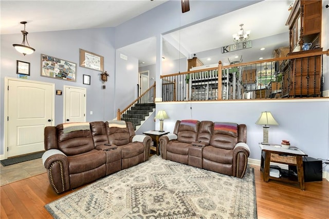 4316 Grand Ave, Leavenworth, KS 66048 - living area with vaulted ceiling, wood finished floors, stairway, baseboards, and a chandelier