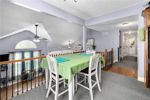 4316 Grand Ave, Leavenworth, KS 66048 - dining area featuring wood finished floors, ceiling fan, vaulted ceiling, baseboards, and carpet