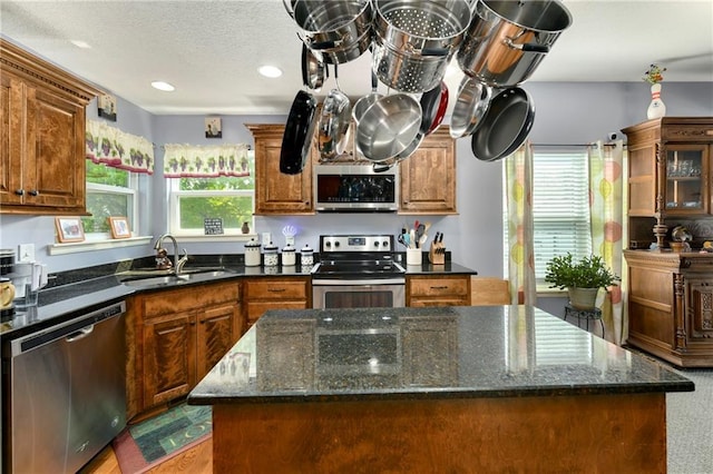 4316 Grand Ave, Leavenworth, KS 66048 - kitchen with appliances with stainless steel finishes, a sink, a center island, dark stone countertops, and recessed lighting