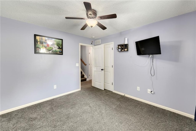 4316 Grand Ave, Leavenworth, KS 66048 - unfurnished bedroom featuring carpet floors, baseboards, a textured ceiling, a ceiling fan, and a closet