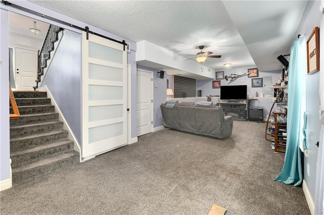 4316 Grand Ave, Leavenworth, KS 66048 - living area featuring a ceiling fan, a barn door, carpet flooring, stairway, and a textured ceiling