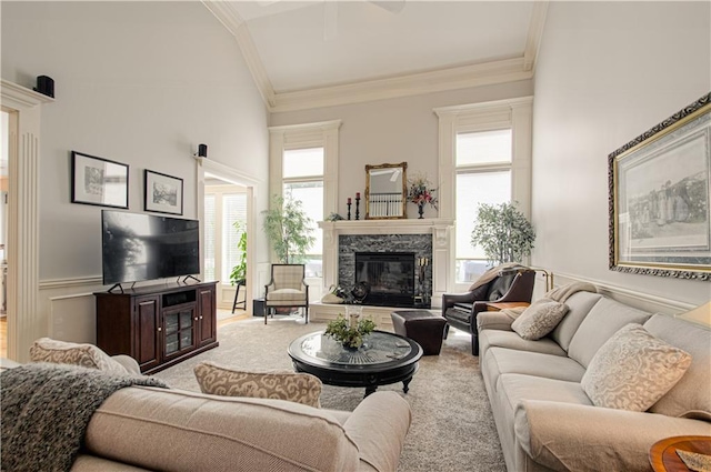 18765 S Alden St, Olathe, KS 66062 - living area featuring ornamental molding, a fireplace, a wainscoted wall, and carpet floors