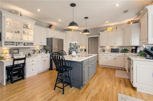 18765 S Alden St, Olathe, KS 66062 - kitchen with white cabinetry, freestanding refrigerator, gray cabinetry, a center island, and recessed lighting