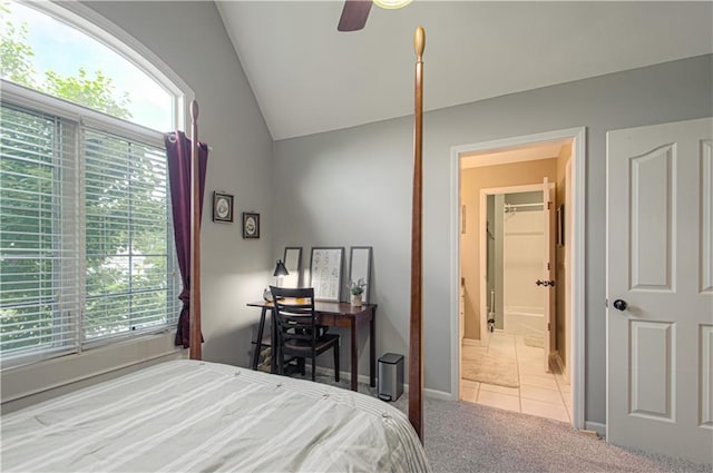 18765 S Alden St, Olathe, KS 66062 - carpeted bedroom featuring vaulted ceiling, multiple windows, tile patterned floors, and ensuite bathroom