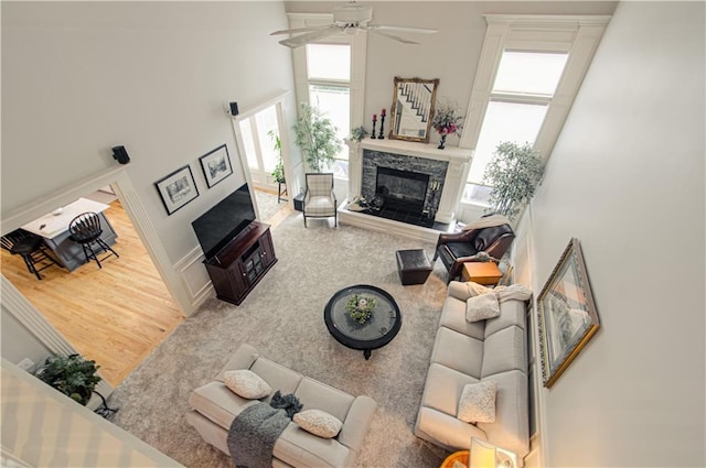 18765 S Alden St, Olathe, KS 66062 - living area with a fireplace, a towering ceiling, ceiling fan, and wood finished floors