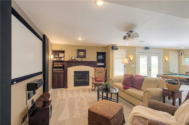 18765 S Alden St, Olathe, KS 66062 - living area with light colored carpet, a fireplace with flush hearth, pool table, french doors, and recessed lighting