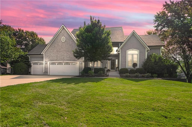 18765 S Alden St, Olathe, KS 66062 - view of front of house featuring an attached garage, concrete driveway, a front lawn, and stucco siding